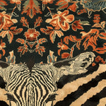 A vibrant Zebra Fusion Hand Tufted Rug with an intricate pattern featuring a zebra motif and colorful floral designs. This large area rug, ideal for a dining room, combines vintage charm with modern aesthetics. Made from high-quality wool, it serves as a stunning dining table rug, enhancing any space with its bold, artistic appeal.