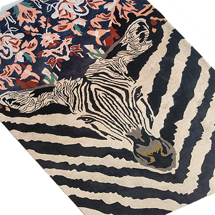 Angled close-up of the zebra rug, striped head meeting a coral-and-navy floral panel