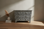 Zebra noir bone inlay 6 drawers chest with swirling black and white concentric patterns.