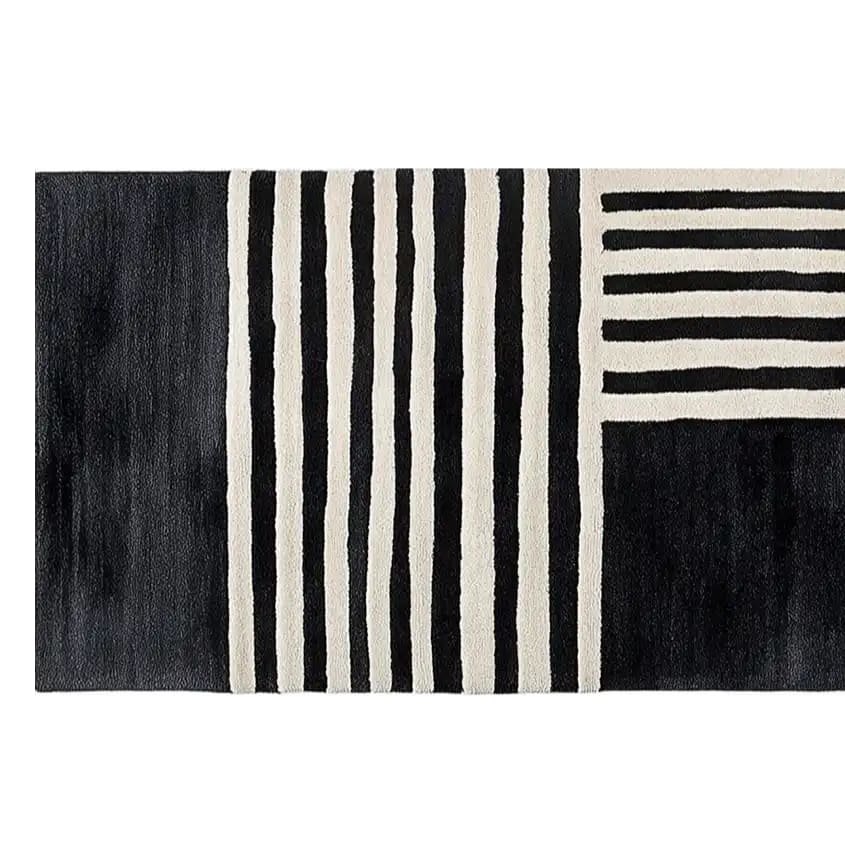 A chic and contemporary runner rug featuring a striking black and white geometric pattern. This hand tufted wool rug, ideal for kitchen runner rugs or hallway runner rug needs, adds a modern touch to any space. Perfect for use as bathroom runner rug or kitchen rugs, offering a stylish and durable option.