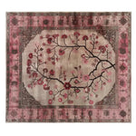 Top view of the Zenwood Sanctuary Knotted Wool Rug, an elegant area rug perfect for living room decor. This 8x10 floral rug features a beautifully intricate design with blooming branches in shades of pink and brown, ideal for those seeking stylish living room area rugs.