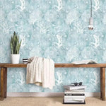 Abstract coastal cottage wallpaper featuring sea creatures and coral patterns in soft blue hues, perfect for a serene home decor.