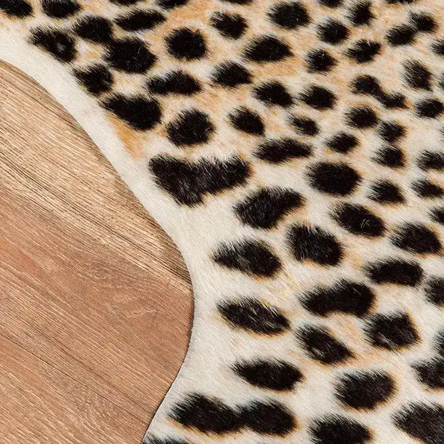 Side edge detail of cheetah faux hide rug curving on wood floor