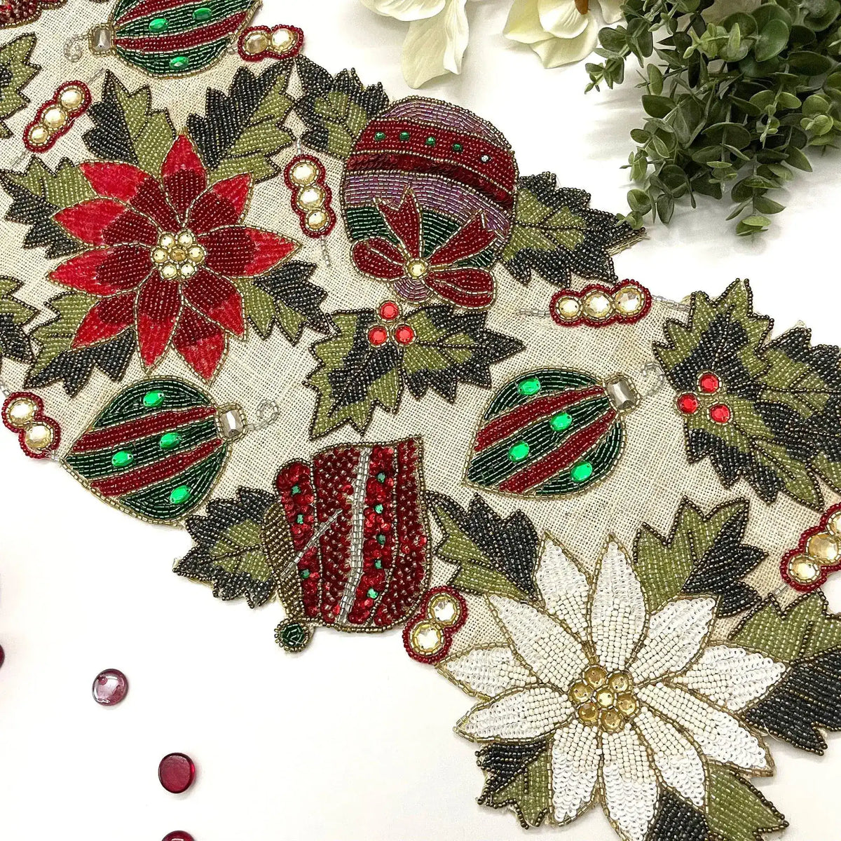 Macro close-up of Christmas Spirit Bells and Flowers beaded runner in red gold and blue beadwork