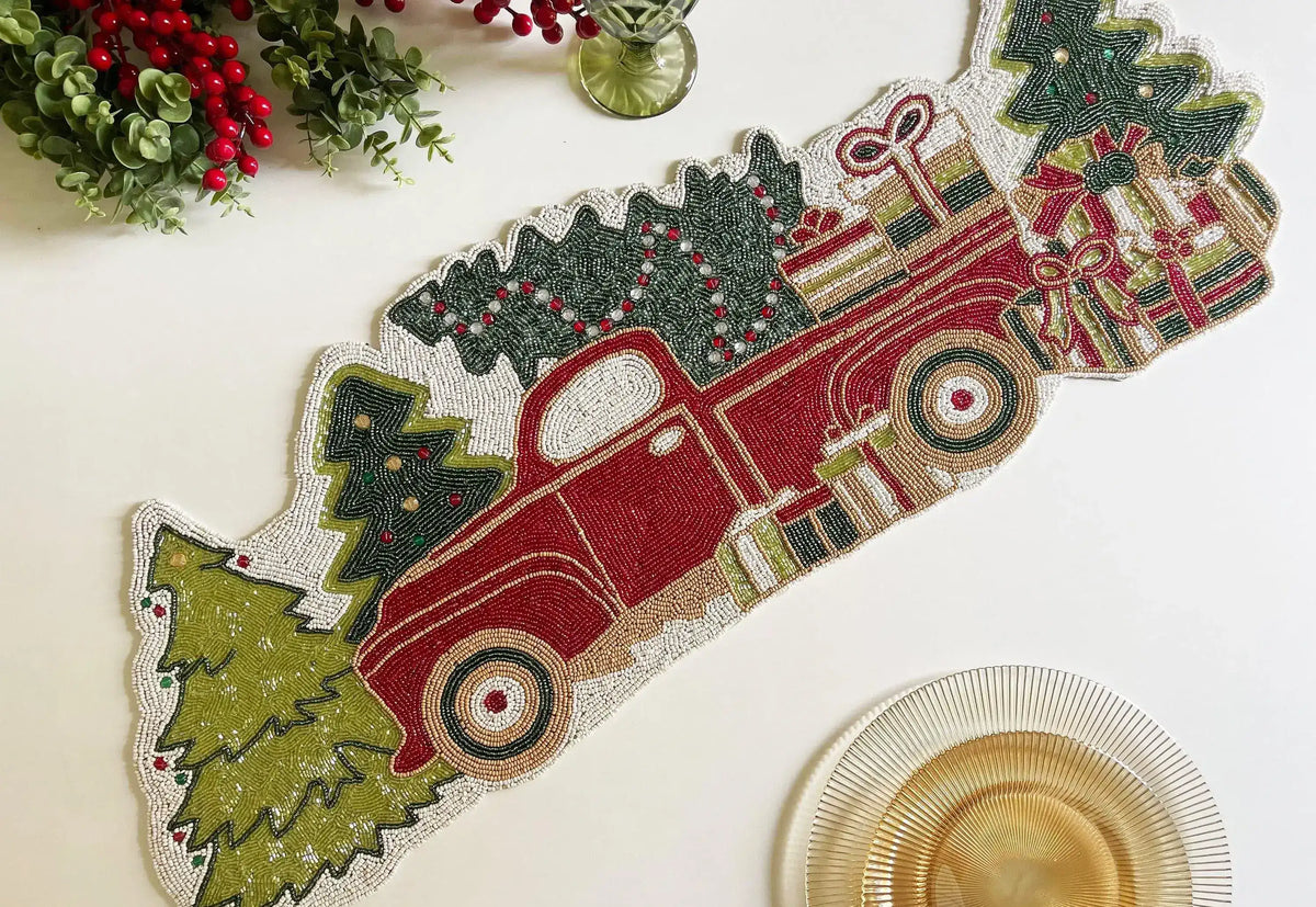 Christmas trees and red trucks beaded table runner flat lay, red vintage truck with green trees and wrapped gifts