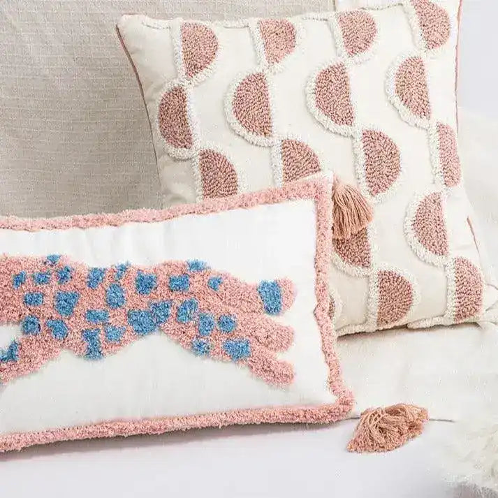 Decorative throw pillow featuring pink leopard embroidery on a white background, styled with a textured design, perfect for home decor.