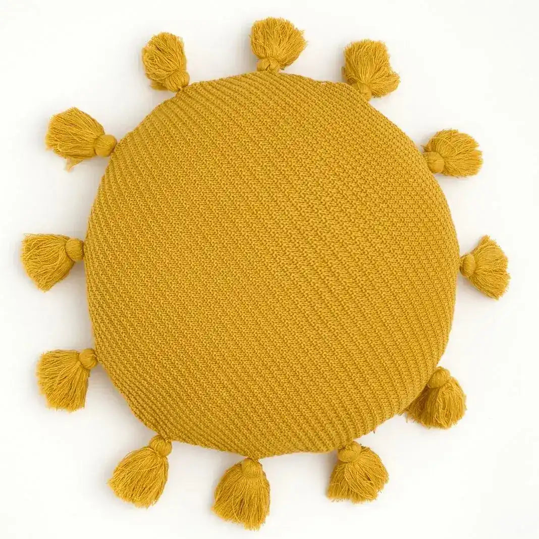 Round yellow decorative throw pillow with tassels around the edge, perfect for adding a pop of color to any room.
