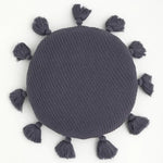 Round decorative throw pillow with tassels in a stylish dark gray color, perfect for adding a cozy touch to any decor.