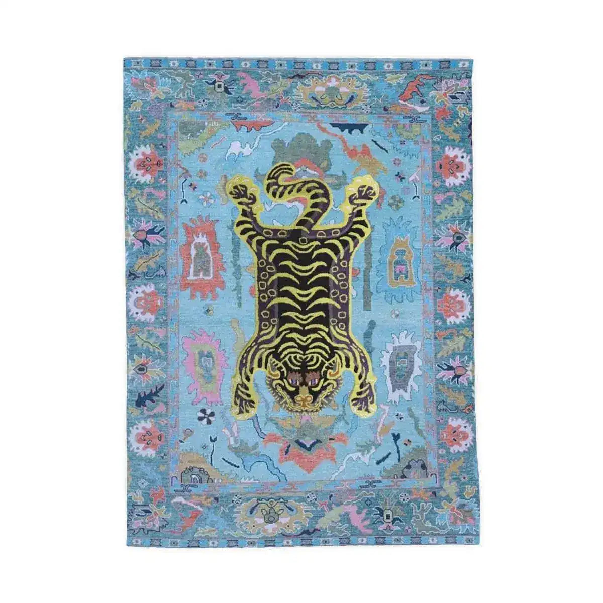 Flat-lay of Tibetan Tiger printed tea towel, blue field, yellow-black tiger and multicolor floral border, white background